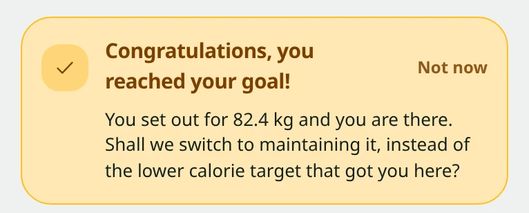 Snapkin app card saying Congratulations, you reached your goal, with the offer to switch to a calorie target that keeps your weight steady.